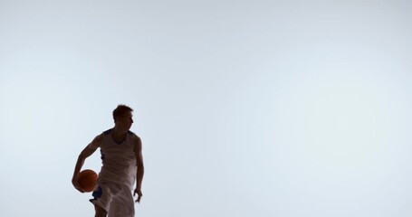 Basketball player lifting ball upward in controlled jump movement. Concept of shooting fundamentals, form analysis, rhythm development, and basketball technique training for coaching materials.