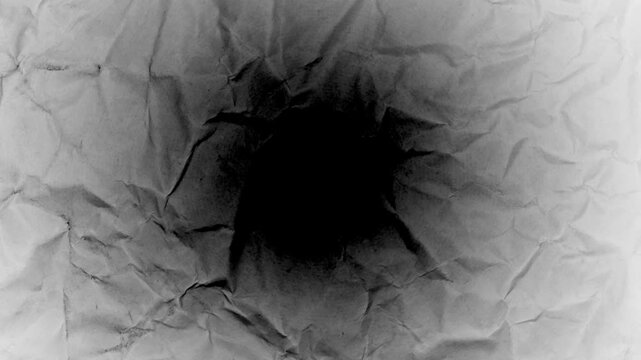Dark grunge crumpled paper texture animation with vignette for spooky horror background.