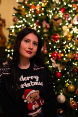 woman in pajamas near the christmas tree