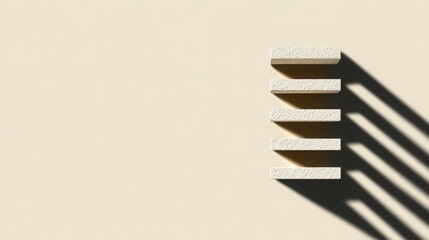 Stack of six rectangular white tiles with textured surfaces arranged vertically on a plain beige background with strong shadow cast by sunlight