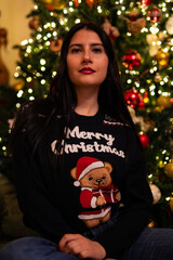 woman in pajamas near the christmas tree