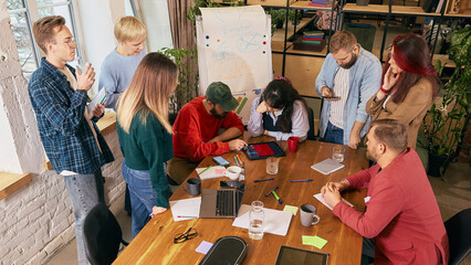 Coworkers reviewing project results during office meeting. Concept of business evaluation, teamwork communication, collaborative analysis and corporate performance.