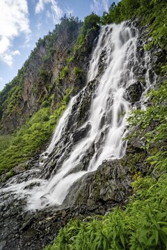 Horsetail Falls waterfall on the Lowe River in a green gorge, long exposure, Keystone Canyon, Richardson Highway, Alaska, USA