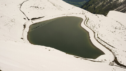 Another onset of winter in May, Riezler Alpsee, an artificially created lake, snow pond, feeds the snow cannons that completely snow the slopes of the Fellhorn and Kanzelwand cable cars, Allgäu Alps, Vorarlberg, Austria