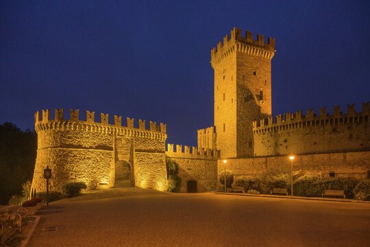 The castle and defensive walls illuminated, Borgo di Vigoleno, Vernasca, Province of Piacenza, Italy
