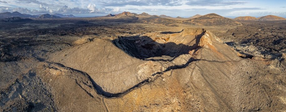 Volc&aacute;n de Las Nueces volcano, picturesque volcanic landscape with volcanic craters and lava fields in morning light, Parque Natural de Los Volcanes, aerial view, Lanzarote, Canary Islands, Spain