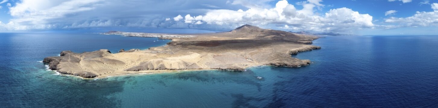 Headland and blue sea, coastal landscape, arid landscape of Los Ajaches Natural Park, aerial view, Lanzarote, Canary Islands, Spain