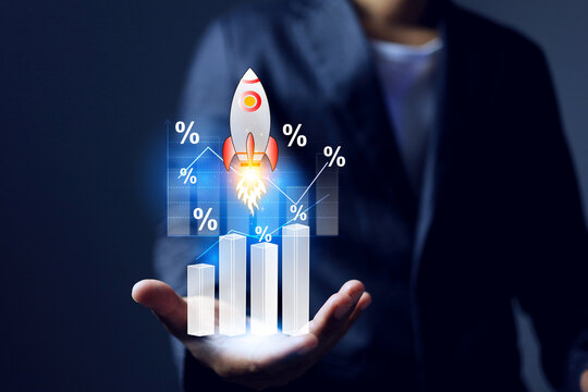 growing up concept with businessman holding rocket rising represent to business fast growing or high return on investment