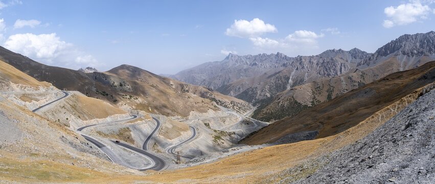 Winding roads on the Pamir Highway, mountain road through an eroded mountain landscape, Kyrgyzstan