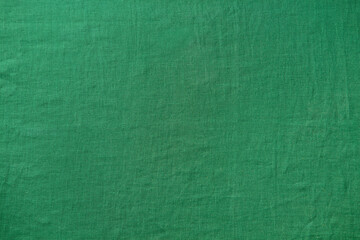 Vibrant green fabric texture. Close up shot, studio background, versatile design element. Copy...