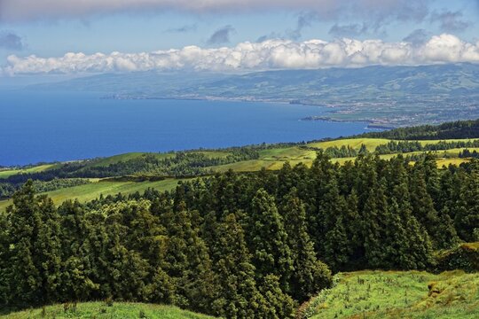 View of a picturesque coastal landscape of the north coast of the island of Sao Miguel near Caples with green hills and clear skies, circular hiking trail, Caldeira das Sete Cidades, Sete Cidades, Sao Miguel Island, Azores, Portugal