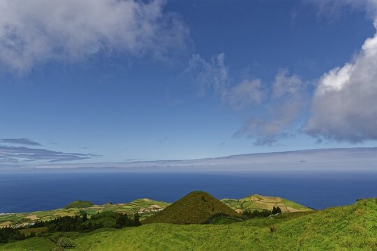 Sweeping views over green volcanic hills that gently fade into the sea under a big sky, Caldeira das Sete Cidades, Sete Cidades, Sao Miguel Island, Azores, Portugal