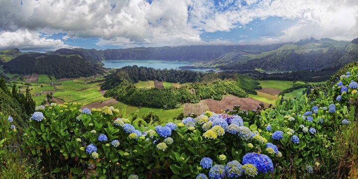 Panoramic view of the picturesque crater landscape of the Caldeira das Sete Cidades with the lake Lagoa Azul and fields, surrounded by flowering hydrangea bushes, Lagoa Azul, Caldeira das Sete Cidades, Sete Cidades, Sao Miguel Island, Azores, Portugal