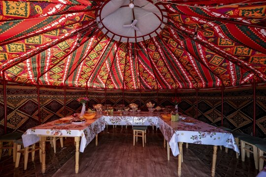 Set table and chairs in a colourful yurt, yurt with traditional patterns, Naryn region, Kyrgyzstan