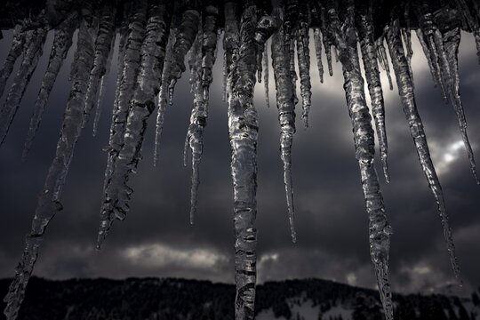 Icicle on gutter in front of dark sky, Balderschwang, Oberallg&auml;u, Bavaria, Germany