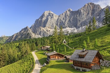 Mountain hut and alp in front of steep mountains in summer, Brandalm, Hoher Dachstein, Austria
