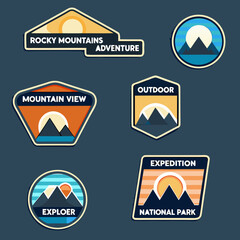 Collection of mountain themed badges and stickers with outdoor adventure text