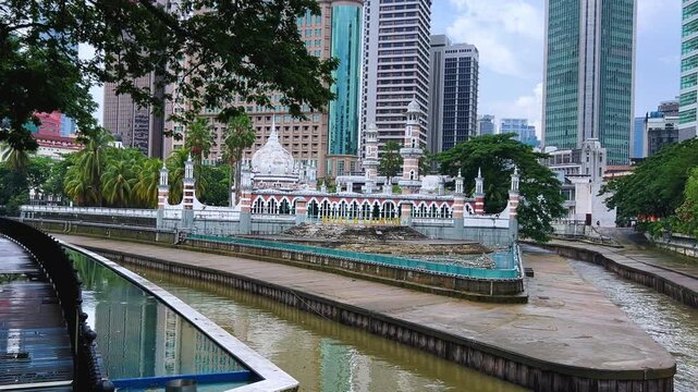 Malaysia - June 10, 2025: Panoramic view of the Masjid Jamek Sultan Abdul Samad Mosque and the confluence of the Klang and Gombak rivers with skyscrapers in the capital city of Kuala Lumpur.4К