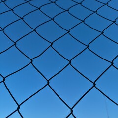 Fototapeta premium chain link fence with blue sky