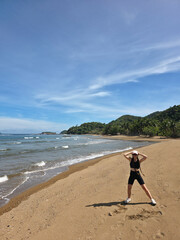 beautiful sand beach on sunny day near blue tropical wave sea with happy women on it. philippines islands. vertical
