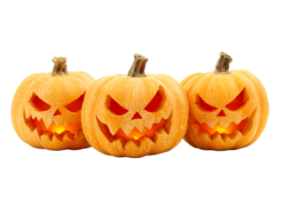 Three carved pumpkins with glowing interiors