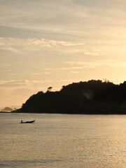 small local boats on turquoise tropical wave sea near philippines islands with beautiful sand beach on gold morning dawn