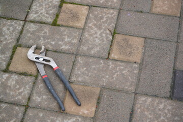 Adjustable pliers or plumbing pliers or adjustable wrench. A universal tool for gripping and...