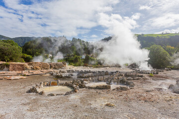 Wide landscape of Caldeiras das Furnas geothermal field with steam vents and boiling mud in S&atilde;o Miguel, Azores.
