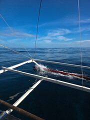 small local boats on turquoise tropical wave sea near philippines islands with beautiful sand beach on sunny day