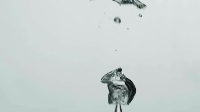 Monochrome water bubble rising, forming a rounded cap above a slender stem in still liquids, softly