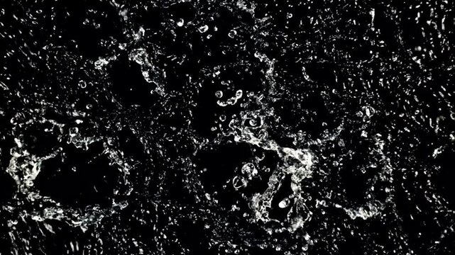 Dark, obsidian backdrop punctuated by bright water splashes and crystalline droplets, glinting glow