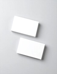 Two blank business cards on a gray surface