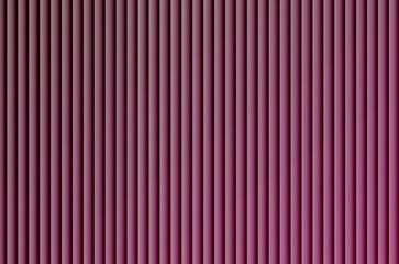 A close-up view of a wall with evenly spaced vertical purple and black stripes creating a gradient effect