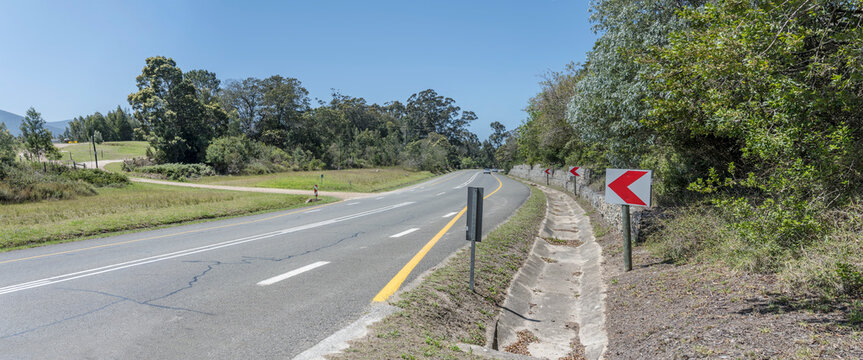 Garden Route road in green countryside, near Bitou, South Africa
