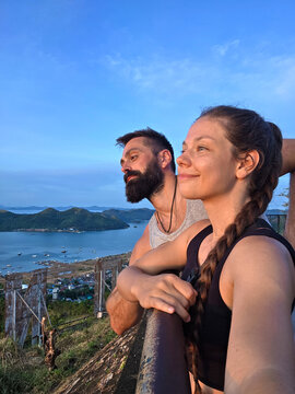 beautiful smiling young couple selfie on morning top view of the Coron city, Busuanga, Philippines. Mountain Tapyas