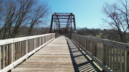 Flying along the walk way and into  inside this historic Parker truss bridge, it was built in 1897 and 1898. Known as the Sutliff Bridge is a bridge over the Cedar River in Iowa. 4k, drone, flying