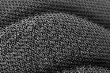Texture of mesh nylon fabric in black color. Carbon fabric