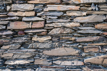 Photograph showcasing rugged limestone and granite wall with moss and shadow play for artistic projects