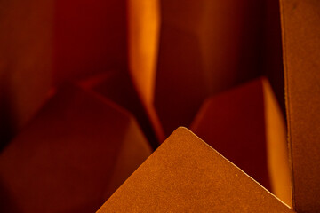 Horizontal orange square bokeh blured abstraction backdrop. Flame Pattern Shape . Aged brown book sitting on bright red table room for copy. Macro, abstract, background picture of a  orange zig . Aged
