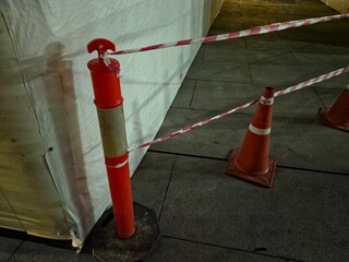 Nighttime construction or restricted area with safety barriers, suitable for themes of urban work, public safety, pedestrian detours, and site maintenance.
