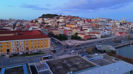 Wide aerial skyline of Lisbon Portugal featuring historic districts, waterfront, bridges and calm Tagus river, presenting a recognizable European travel destination