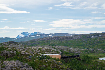 Fototapeta premium Ore train between Sweden and Norway on its way through the mountains.