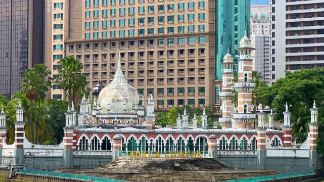 Malaysia - June 10, 2025: Panoramic view of the Masjid Jamek Sultan Abdul Samad Mosque and the confluence of the Klang and Gombak rivers with skyscrapers in the capital city of Kuala Lumpur.4К