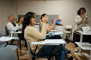 Students and instructor applauding during classroom lecture
