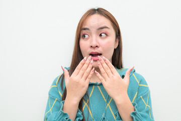 Portrait of a young surprised Asian woman against white background
