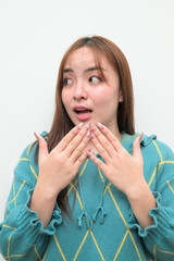 Portrait of a young surprised Asian woman against white background