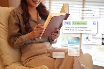 Asian adult woman reading book enjoying modern augmented reality learning experience with digital notifications education technology at home for knowledge study growth