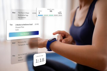 Adult woman using smartwatch tracking fitness metrics managing workout schedule yoga exercise achieving wellness goals at home