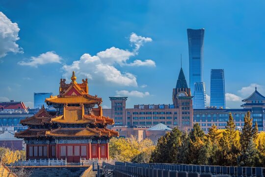 A stunning view of Beijing's Forbidden City Corner Tower with modern skyscrapers like China Zun Tower in the background, showcasing a blend of ancient and contemporary architecture.