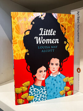 Little Women book cover by Louisa May Alcott featuring two sisters in a vibrant floral scene